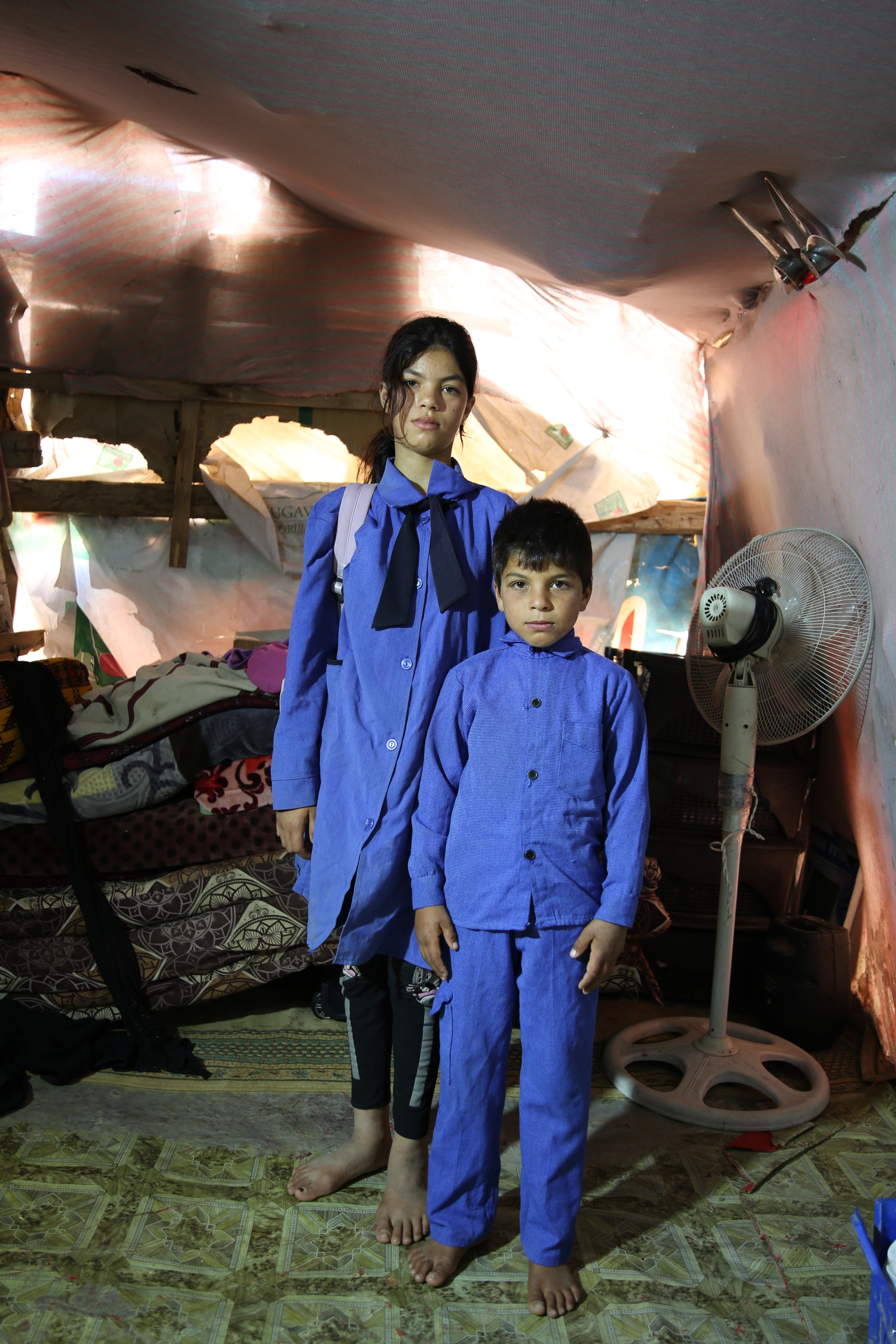 A 12-year-old Jordanian student with her brother © Nathalie Bertrams / GAGE 2024