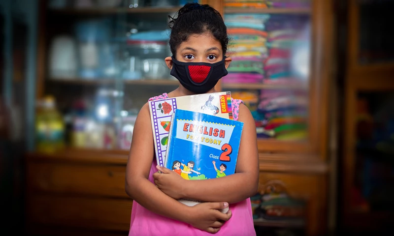 A_teenage_girl_wearing_a_protective_cloth_mask_against_transmissible_COVID-19_diseases_and_she_stay_his_home_at_Dhaka_
